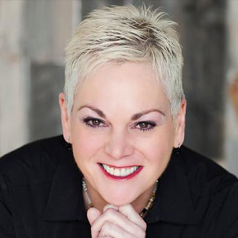 Mary Rascon, Creative Director of illuminate Salon smiling.