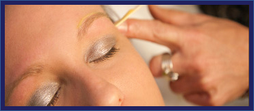 woman getting her eyebrow waxed